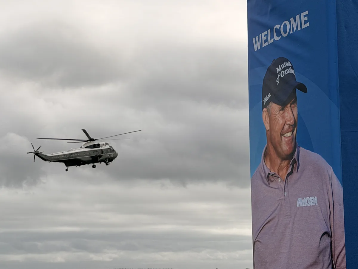 A US presidential helicopter approaching Doonbeg past an Amgen Irish Open welcome banner